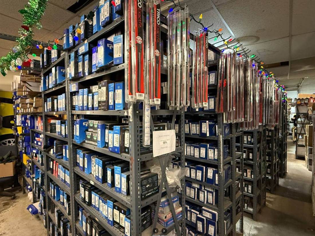 Fully stocked parts shelves inside the SPH Auto Parts warehouse
